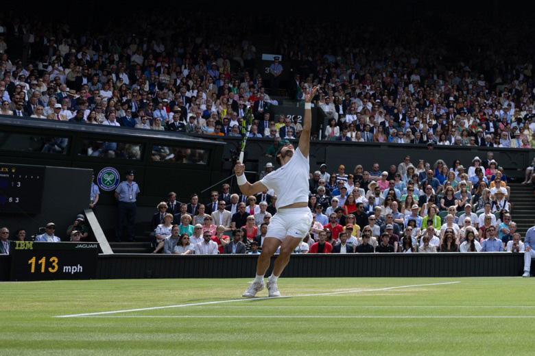 Carlos Alcaraz serving during a match at Wimbledon