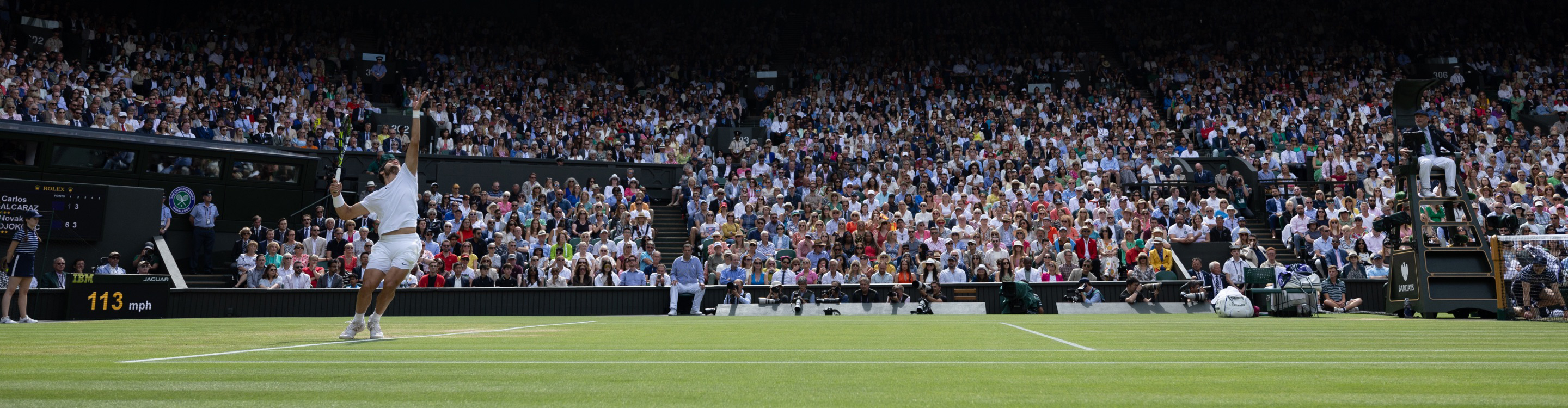 Carlos Alcaraz serving during a match at Wimbledon